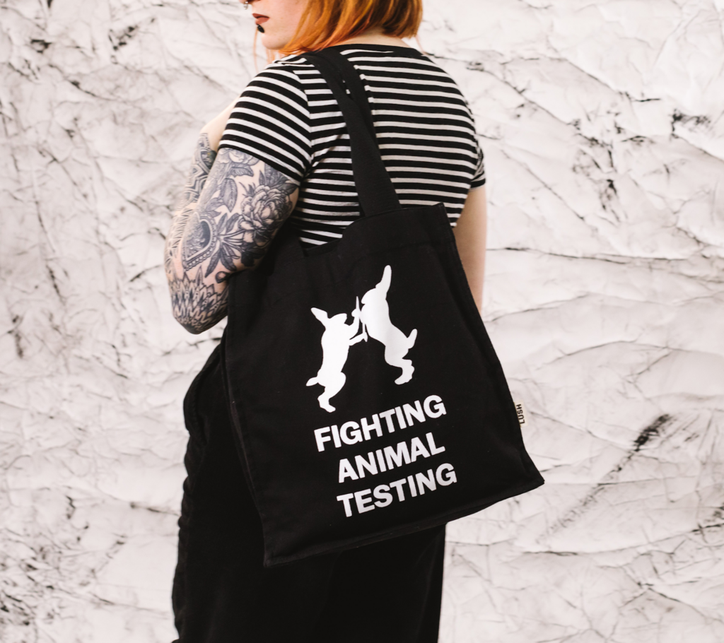 a girl wearing a bag that says "fight animal testing"
